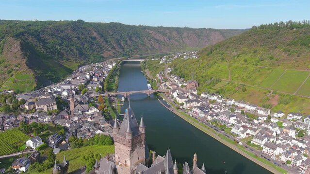 Cochem, Germany: Aerial view of Cochem Imperial Castle (Reichsburg Cochem), medieval hill-top castle with quadrangular tower, lush valley of river Moselle - landscape panorama of Europe from above
