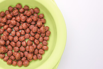 Chocolate flakes plate isolated close up. Chocolate balls. Breakfast.