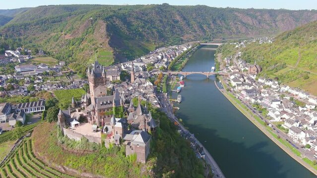 Cochem, Germany: Aerial view of Cochem Imperial Castle (Reichsburg Cochem), medieval hill-top castle with quadrangular tower, lush valley of river Moselle - landscape panorama of Europe from above