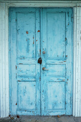 vintage old wooden blue door with peeling paint