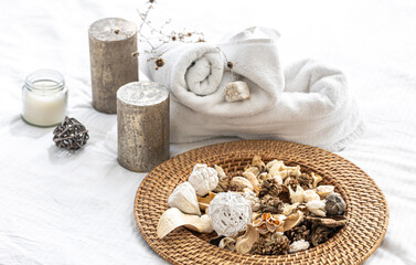 Spa composition with dried flowers, candles and towels.