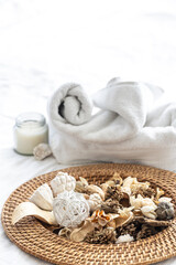 Spa composition with dried flowers, candles and towels.