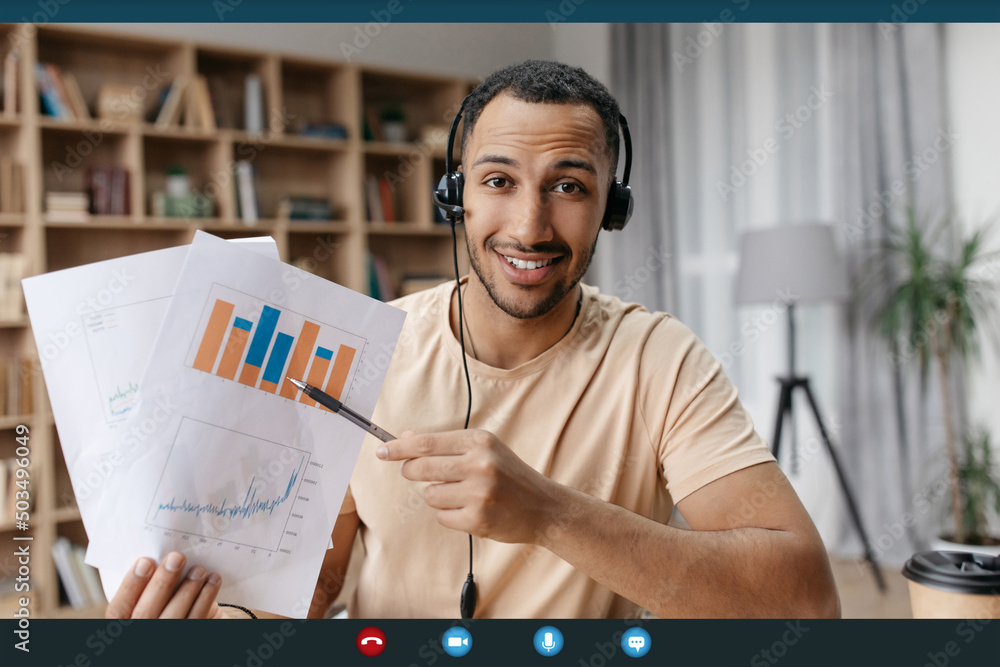 Poster happy arab businessman making teleconference with colleagues from home, showing reports with graphs 