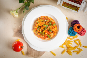 Spicy Penne Masala pasta withraw tomato in a bowl isolated on background side view