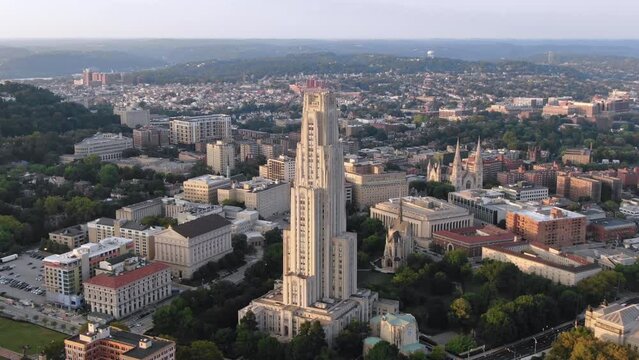 An extreme aerial wide establishing shot of the Cathedral of Learning on Pitt's campus in Pittsburgh's Oakland district on late summer evening.