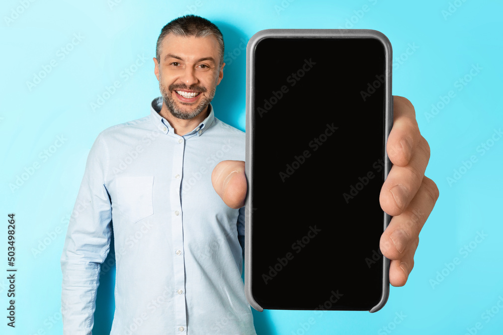 Poster Man Showing Huge Smartphone With Blank Screen Over Blue Background
