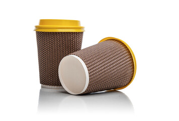 Two paper cups of coffee with a yellow lid. Coffee paper cup isolated on white background.