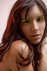 Obraz premium Studio Portrait of Young Fresh Faced Fashion Model Looking at Camera. Attractive Young Brunette Woman with Perfect Beach Hair and Makeup