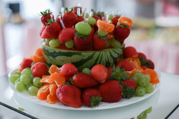Fototapeta na wymiar a plate with berries strawberries raspberries and blueberries on a table in a restaurant