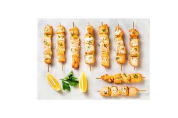 Grilled salmon fish kebabs on the white plate