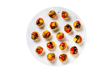 Naklejka na ściany i meble Mini tartlets with grilled vegetables. Delicious breakfast or wine snack. White background, top view