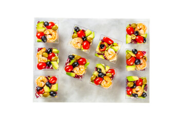 Served Caesar salad with shrips in a plastic boxes, catering food