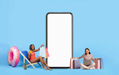 Women posing with white empty smartphone screen and shopper bags