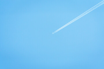 an airplane crossing a clear sky