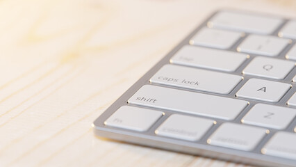 Close-up of keyboard placed on wooden table. Selective focus and Space for banner and logo. 3D Render.