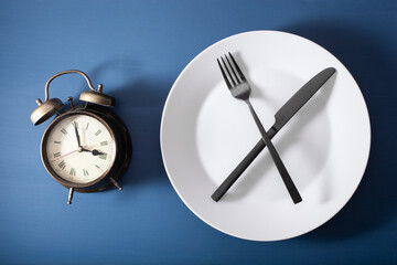 concept of intermittent fasting, ketogenic diet, weight loss. fork and knife on a plate and...