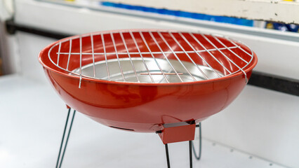 Empty new barbecue grill on display in the shop window, no body