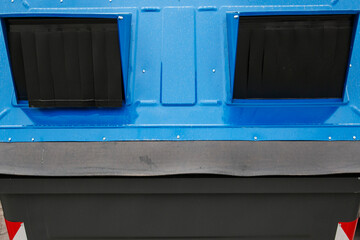 Close up of a blue recycling bin in Rome, Italy.