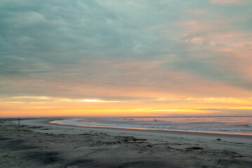 Colorful orange dawn sky, beach, sunrise, ocean, waves, Hunting Island, South Carolina coast