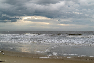 Fototapeta na wymiar Moody sky with gray clouds over a South Carolina Beach, Atlantic Ocean
