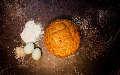 Round sourdough bread with blue eggs, pink salt, and flour. 