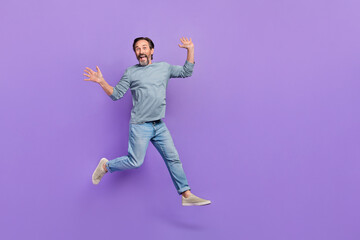 Fototapeta na wymiar Full body photo of cheerful aged man have fun jumper wear casual clothes isolated over purple color background