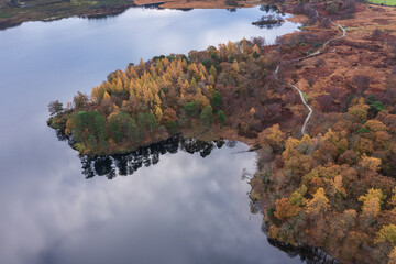 Stunning aerial drone bird's eye view landscape image of Derwentwater in Lake District with vibrant Autumn colors