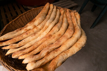 Stack of delicious traditional Georgian Shoti bread in a wicker basket