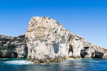 Fototapeta na wymiar Waves crash against cliffs and sea caves