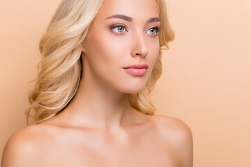 Naklejka premium Cropped view portrait of attractive perfect wavy-haired girl flawless makeover isolated over beige pastel color background