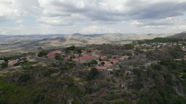 Scenic stone Village on remote location, Mountain range background, Sortelha. Upwards pullback
