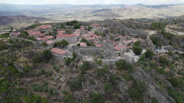 Orbiting view Stone houses Village Inside Fortification walls, on greenery Hilltop, Sortelha. Portugal