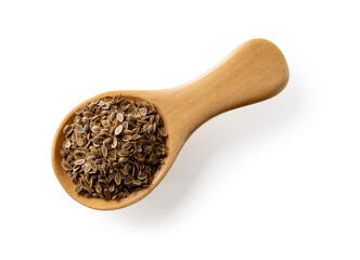 Raw dill seeds in a wooden spoon isolated on a white background. Wooden spice shovel full of dry anethum graveolens fruits cutout. Organic spices, seasonings and condiments. Medicinal herb.