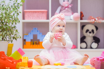baby playing with colourful building blocks at home or kindergarten