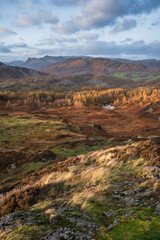 Majestic Autumn sunset landscape image from Holme Fell looking towards Coniston Water in Lake District