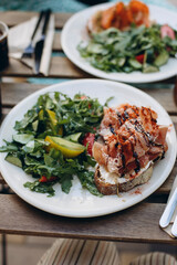 bruschetta with jamon and cream cheese. fresh salad with bruschetta on a plate. gourmet sandwich with jamon and balsamic cream