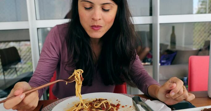 Woman eating pasta spaghetti for lunch