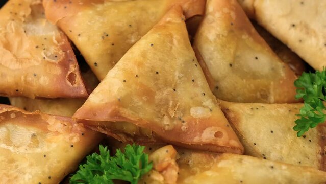 Fried samosas with vegetable filling, popular Indian snacks. Rotating video