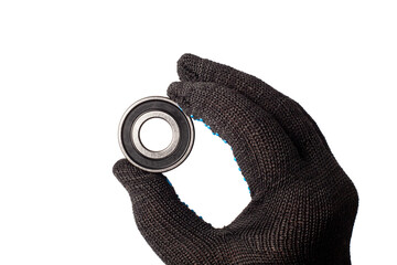 Male hand in work glove holding metal roller bearing. Ball bearing isolated. Super Precision Ball...