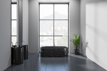 Front view on dark bathroom interior with bathtub, panoramic window