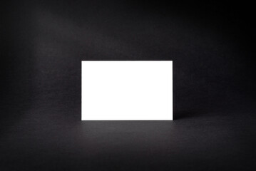 Mockup of business card isolated on black textured background with shadows
