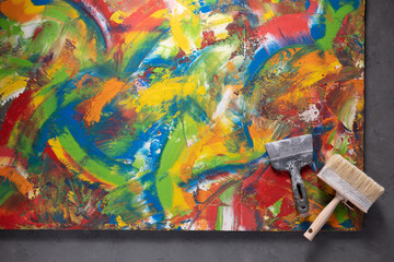 Abstract painting and construction tool on wall background. Creative design concept idea