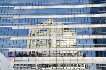 Reflection of luxury buildings on blue glass of the building, Reflections background at Thailand.