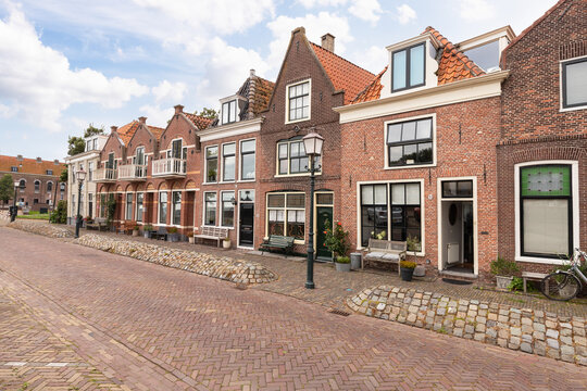 Old historic houses along the quay of the harbor in the city of Hoorn in the Netherlands.