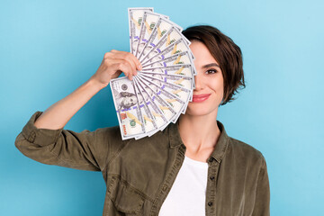 Photo of nice young short hairstyle lady hold money wear khaki shirt isolated on blue color background