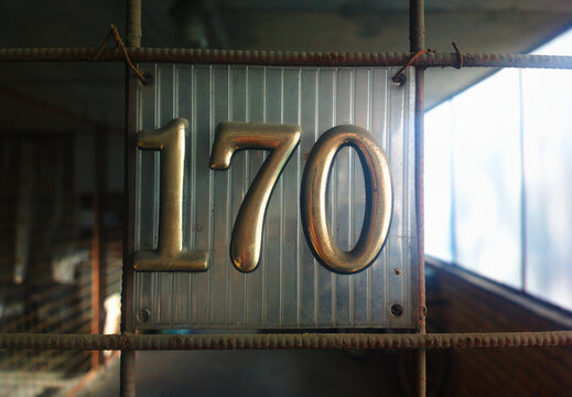 Vintage golden number 170 banner at car garage
