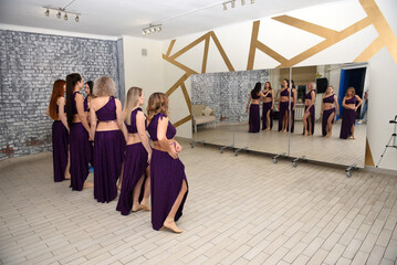 A group of beautiful girls in a choreography studio for training dancing in oriental outfits