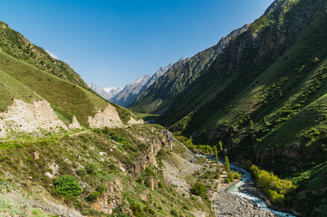 Fototapeta na wymiar Alpine narrow valley on a sunny summer day.