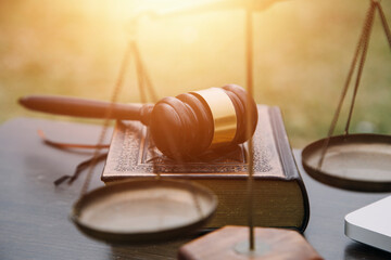 Justice and law concept.Male judge in a courtroom with the gavel, working with, computer and...