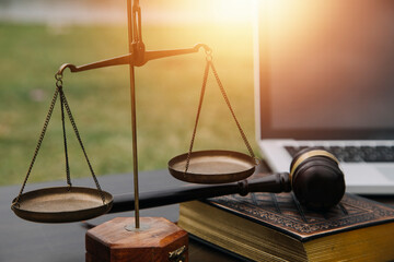 Justice and law concept.Male judge in a courtroom with the gavel, working with, computer and...